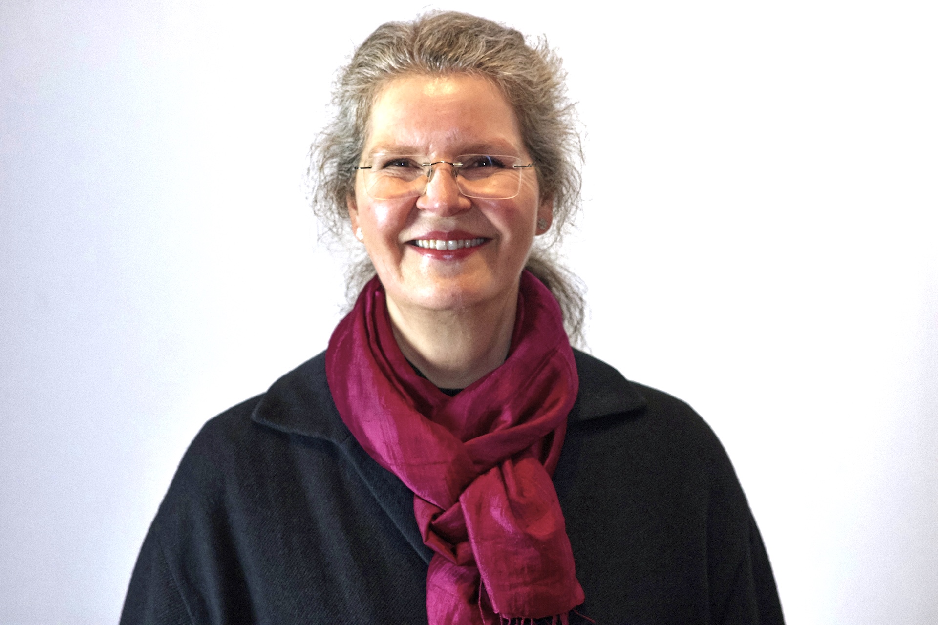 Eine Frau mit Brille und rotem Schal